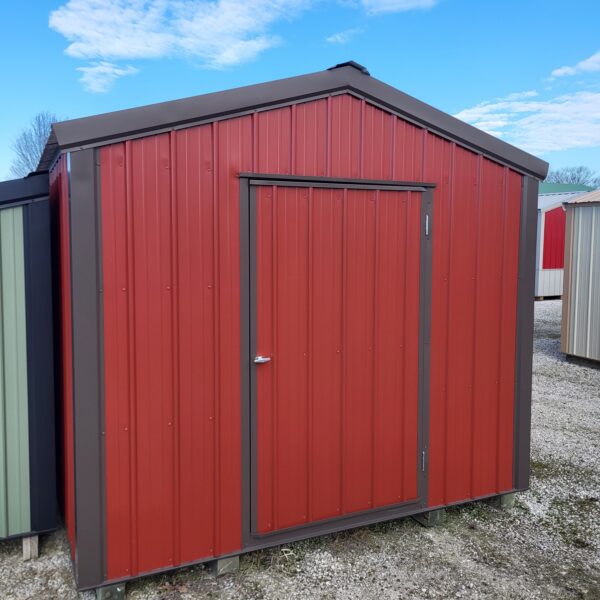 Red metal shed against blue sky