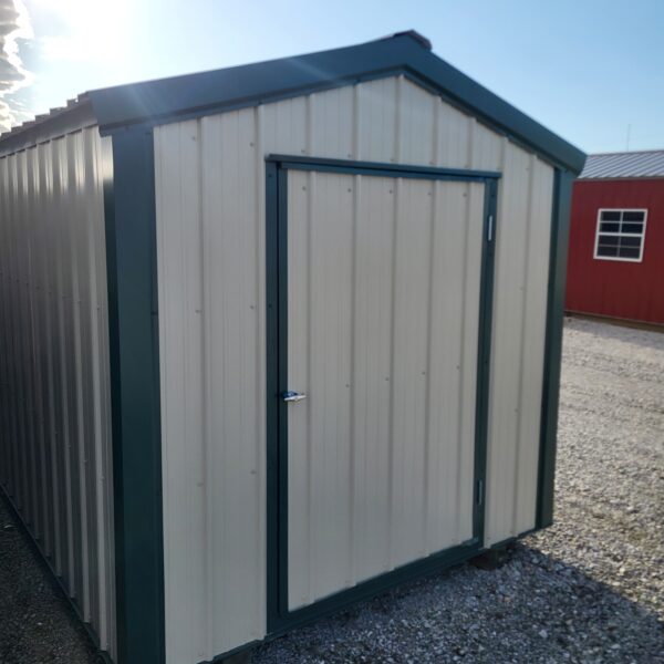 Metal storage shed with green trim
