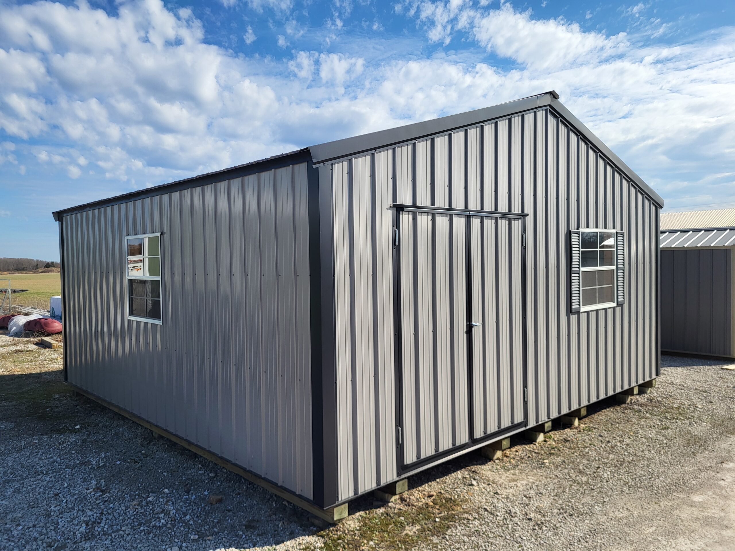Metal storage shed on gravel foundation