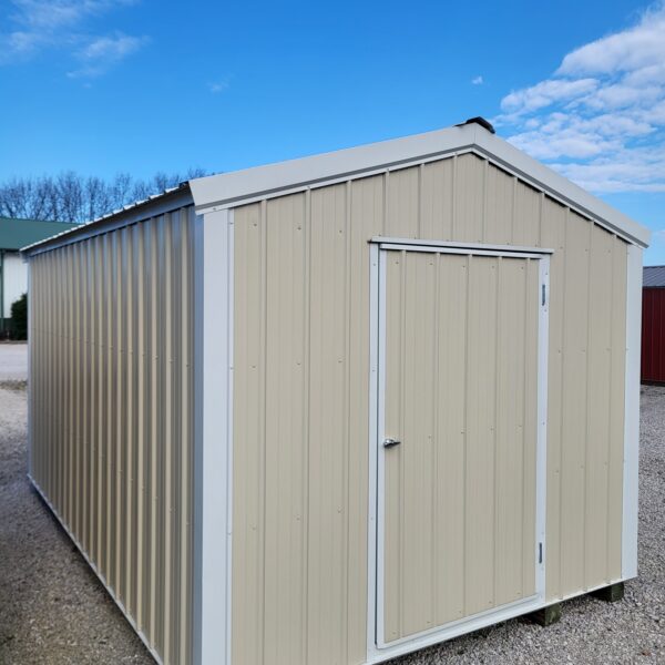 Metal storage shed on gravel surface