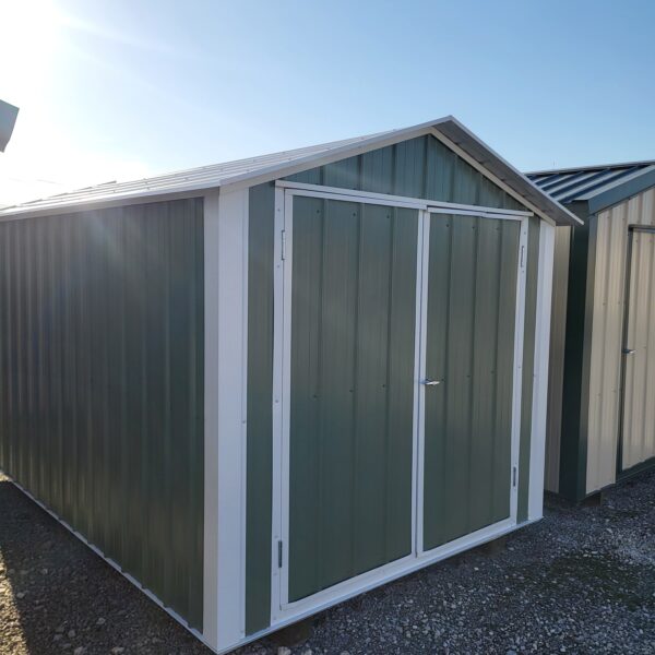 Green metal storage shed outdoors