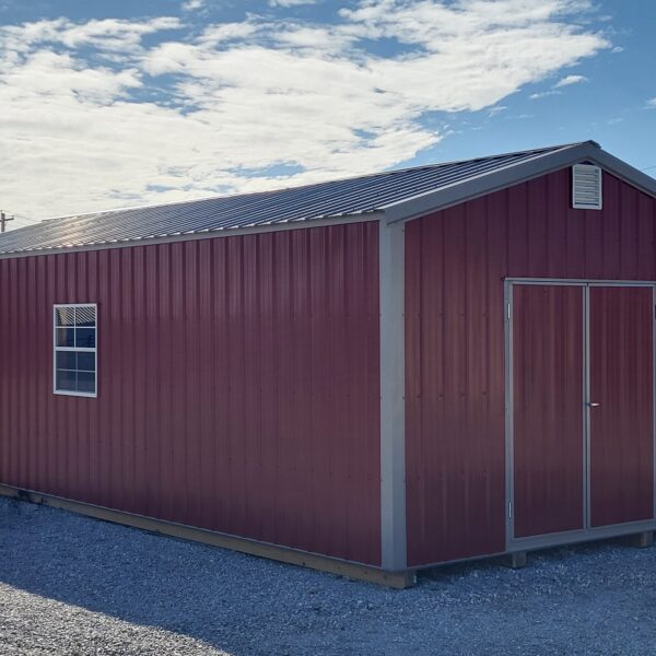 Red metal shed under blue sky