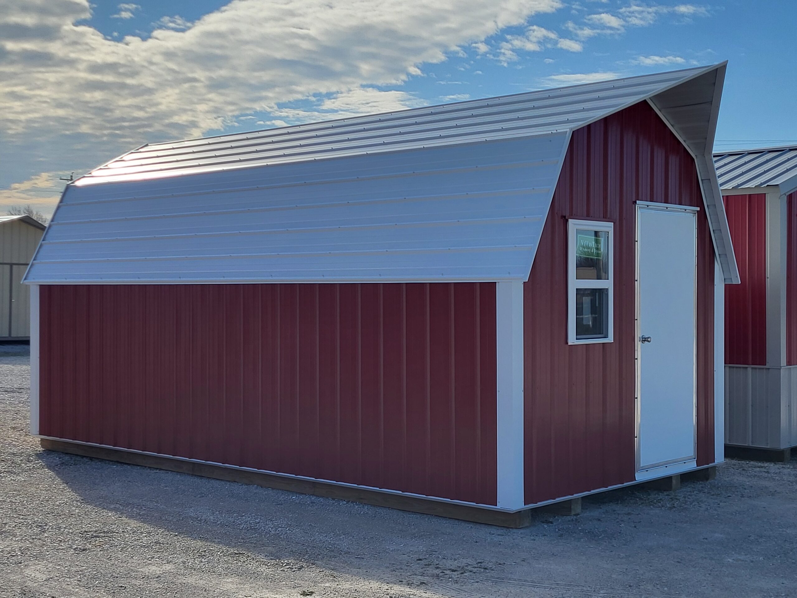 Red and white metal storage shed